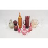 Collection of coloured glassware including a Victorian cranberry glass jug, a bowl, an engraved