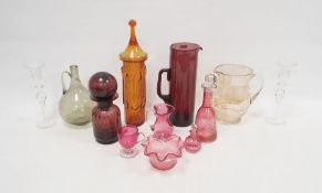 Collection of coloured glassware including a Victorian cranberry glass jug, a bowl, an engraved
