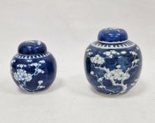 Two Chinese blue and white prunus decorated lidded ginger jars, each with double-ring mark to base