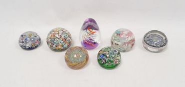 Seven paperweights including a pair of Perthshire scrambled millefiori paperweights, each dated