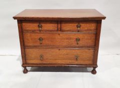 20th century oak chest of two short and two long drawers, on carved circular feet, bulbous