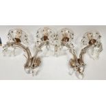Pair of 20th century glass two-light wall sconces each with petal-shaped drip pans suspending