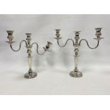 Pair of silver plated and weighted three-branch candelabra on circular bases (2)