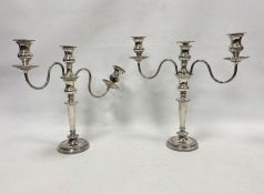 Pair of silver plated and weighted three-branch candelabra on circular bases (2)