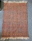 Eastern style red ground rug with geometric pattern to single floral border, 126cm X 87cm