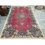 North East Persian Signed red ground Meshed carpet with large centralised floral medallion