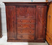 Victorian mahogany breakfront compactum with central cupboard over four  drawers flanked by two