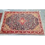 North West Persian Sarouk blue ground rug with central floral medallion enclosed by floral pattern
