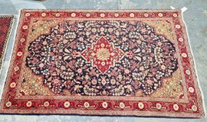 North West Persian Sarouk blue ground rug with central floral medallion enclosed by floral pattern
