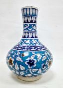 Isnik-style bottle-shaped vase, probably 19th century, decorated with a band of leafy flowers