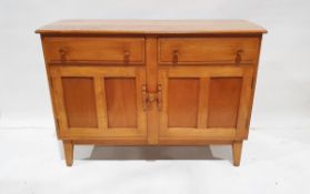 20th century light stained wood sideboard having two frieze drawers, cupboard below enclosed by