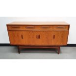 20th century teak E. Gomme for G-plan sideboard of four short drawers over three cupboards on