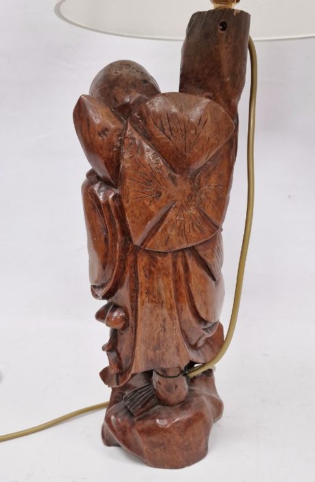 Chinese carved hardwood figural lamp base, 20th century, formed as a man holding on staff, on - Image 2 of 2