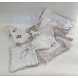 Three vintage damask table cloths, an embroidered table cloth, eight machined lace and embroidered