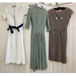 1950's and 60's vintage dresses to include a white poplin shirt waist with navy buttons and navy
