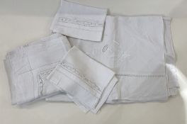 A vintage linen embroidered large double sheet, a single embroidered linen sheet and matching