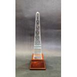 Tiffany & Co clear glass obelisk on wooden stand, engraved detail, 'Tiffany & Co' mark to base of