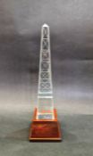 Tiffany & Co clear glass obelisk on wooden stand, engraved detail, 'Tiffany & Co' mark to base of