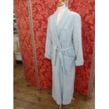 A pale blue wool dressing gown, labelled L. Tavernier, with monogrammed breast pocket, tie belt,