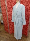 A pale blue wool dressing gown, labelled L. Tavernier, with monogrammed breast pocket, tie belt,