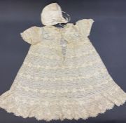 An unbleached machine bobbin lace baby dress, an unbleached lace reticule, a satin and lace baby's