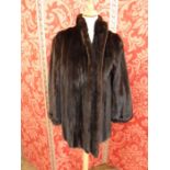 Black 'batwing sleeve' mink coat, UK size L. and a stranded black mink three quarter length jacket,