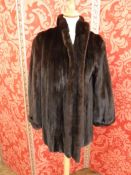 Black 'batwing sleeve' mink coat, UK size L. and a stranded black mink three quarter length jacket,