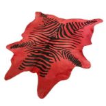 A large cow hide fur rug, dyed red with black stripes 'a la Zebra' Condition ReportApprox 205cm x