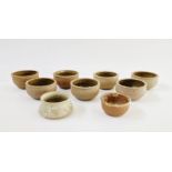 Seven similar studio pottery bowls, unmarked, a Paul Metcalfe studio pottery bowl (chips to top rim)