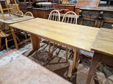 20th century pine refectory table, the plank top on two pedestal supports joined by stretcher,