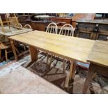 20th century pine refectory table, the plank top on two pedestal supports joined by stretcher,