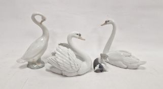 Two Lladro models of swans, naturalistically modelled, one swan with wings outstretched, 21cm
