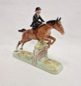 Beswick pottery model of a horse and rider jumping a fence, printed black marks, the female rider