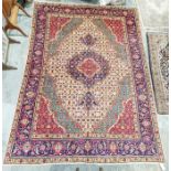 Northwest Persian cream ground Tabriz carpet with central floral medallion on floral field to