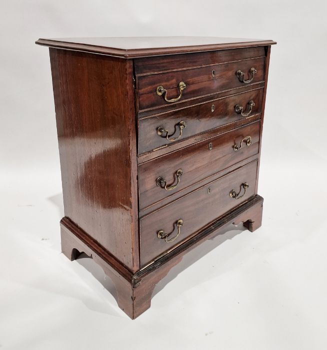 Mahogany cupboard with two hinged doors (four dummy drawers), brass swan neck handles 74 x 65 cms