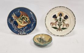 Two various continental slipware and lustre pottery dishes painted with fish and a plate painted