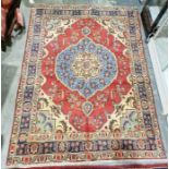 North west Persian red ground Tabriz rug with large central floral medallion on floral field to