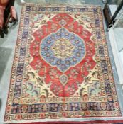 North west Persian red ground Tabriz rug with large central floral medallion on floral field to