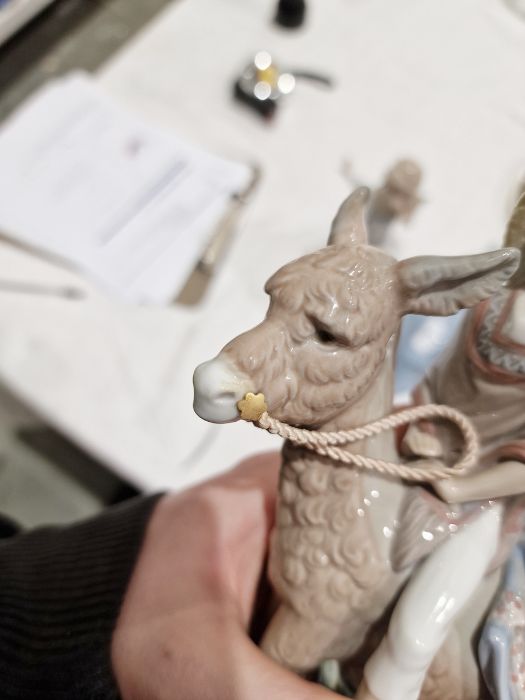 Five Lladro figures including a boy and girl riding a donkey, a pair of girls with baskets of - Image 8 of 10