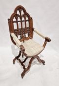 Victorian carved oak Gothic X-frame chair, the pointed arched back fretwork carved with trefoil