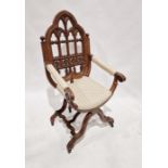 Victorian carved oak Gothic X-frame chair, the pointed arched back fretwork carved with trefoil