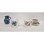 Pair of 19th century English porcelain two-handled motto loving cups, each painted with flowers,