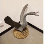 Bronzed finish modern garden cast model of a swan with wings displayed, on circular base, 79cm