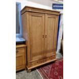 Early 20th century pine wardrobe with pair of cupboards, pair of drawers below, on bun feet, H.