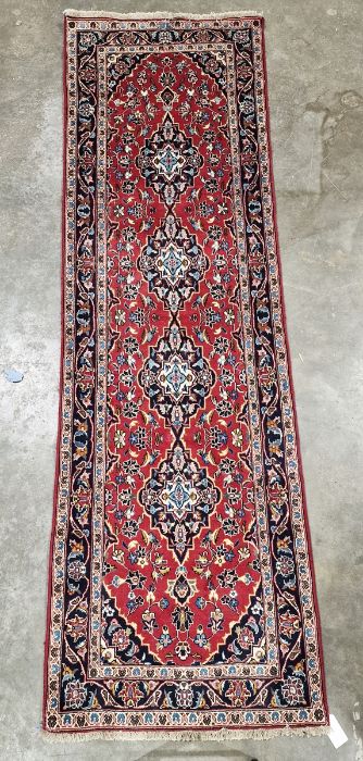 Central Persian red ground Kashan runner with four floral medallions on a herati field, multiple