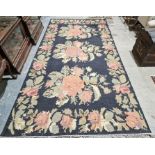 Modern Oka black ground kilim with three central floral medallions, single floral border 335cm X