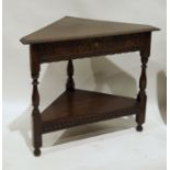 Carved oak corner occasional table with single frieze drawer, having lunette carving and undershelf