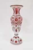 Late 19th/early 20th century Bohemian glass vase with white overlay cut back to cranberry glass,