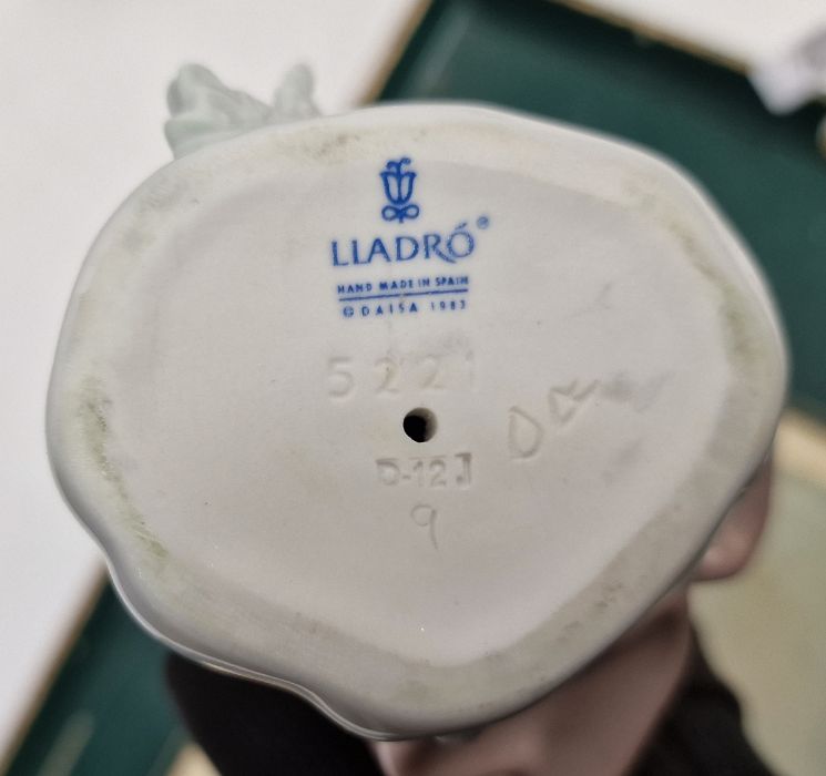 Five Lladro figures including a boy and girl riding a donkey, a pair of girls with baskets of - Image 2 of 10