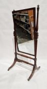 Mahogany cheval robing mirror, the rectangular plate with ebonised borders, on reeded uprights,